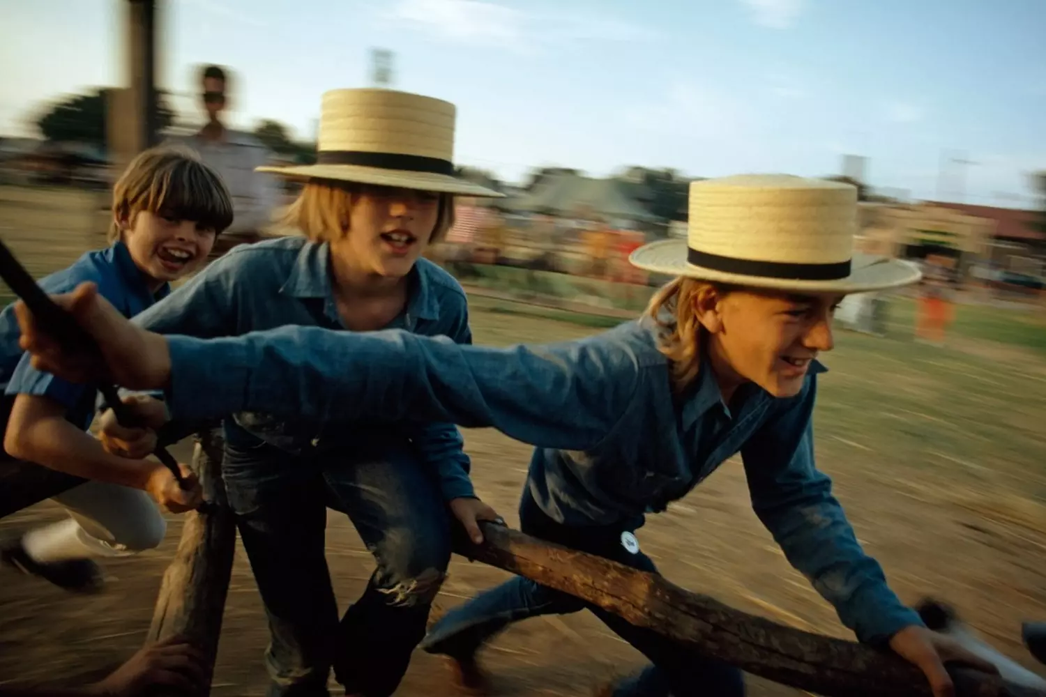 Joyful Amish kids playing in the countryside Amish children playing together in traditional clothes outdoors
