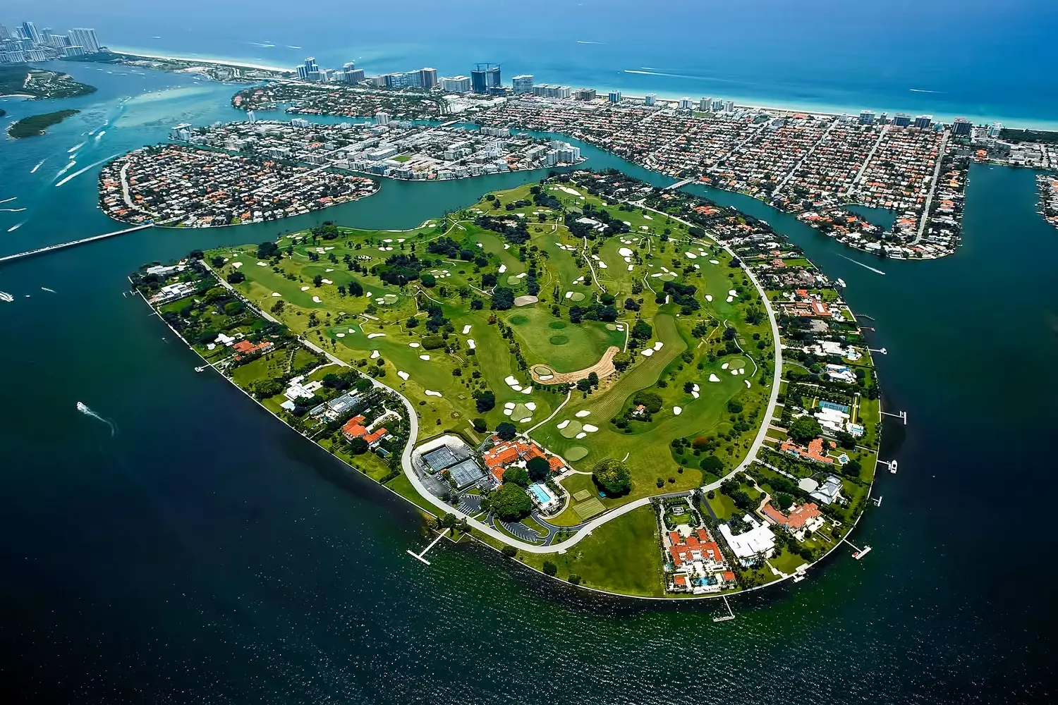 Indian Creek from a bird's-eye view: view of the gated millionaires' island Aerial photo of Indian Creek Island with views of villas, golf course, and bay