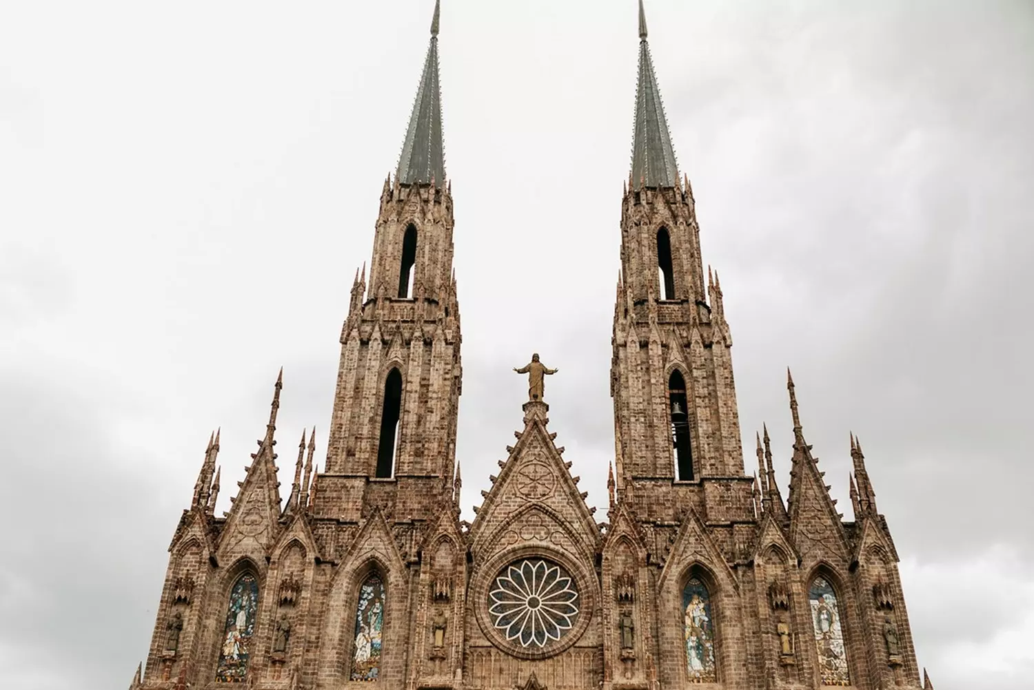 Gothic Grandeur: Architectural Masterpieces of American Cathedrals Majestic Gothic cathedral in the United States, with towering spires, intricate stone carvings, and sunlit stained-glass windows