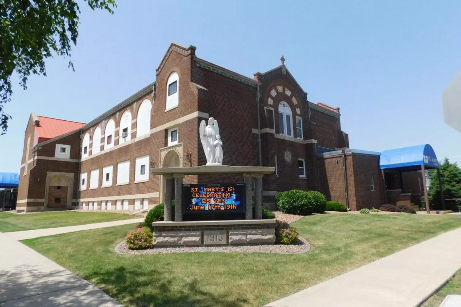 Catholic Schools in the US: Where Faith Meets Knowledge Faith-Based Education in Action: A Catholic School in the U.S. with a Prominent Cross on Its Facade, Students in Uniform Heading to Class