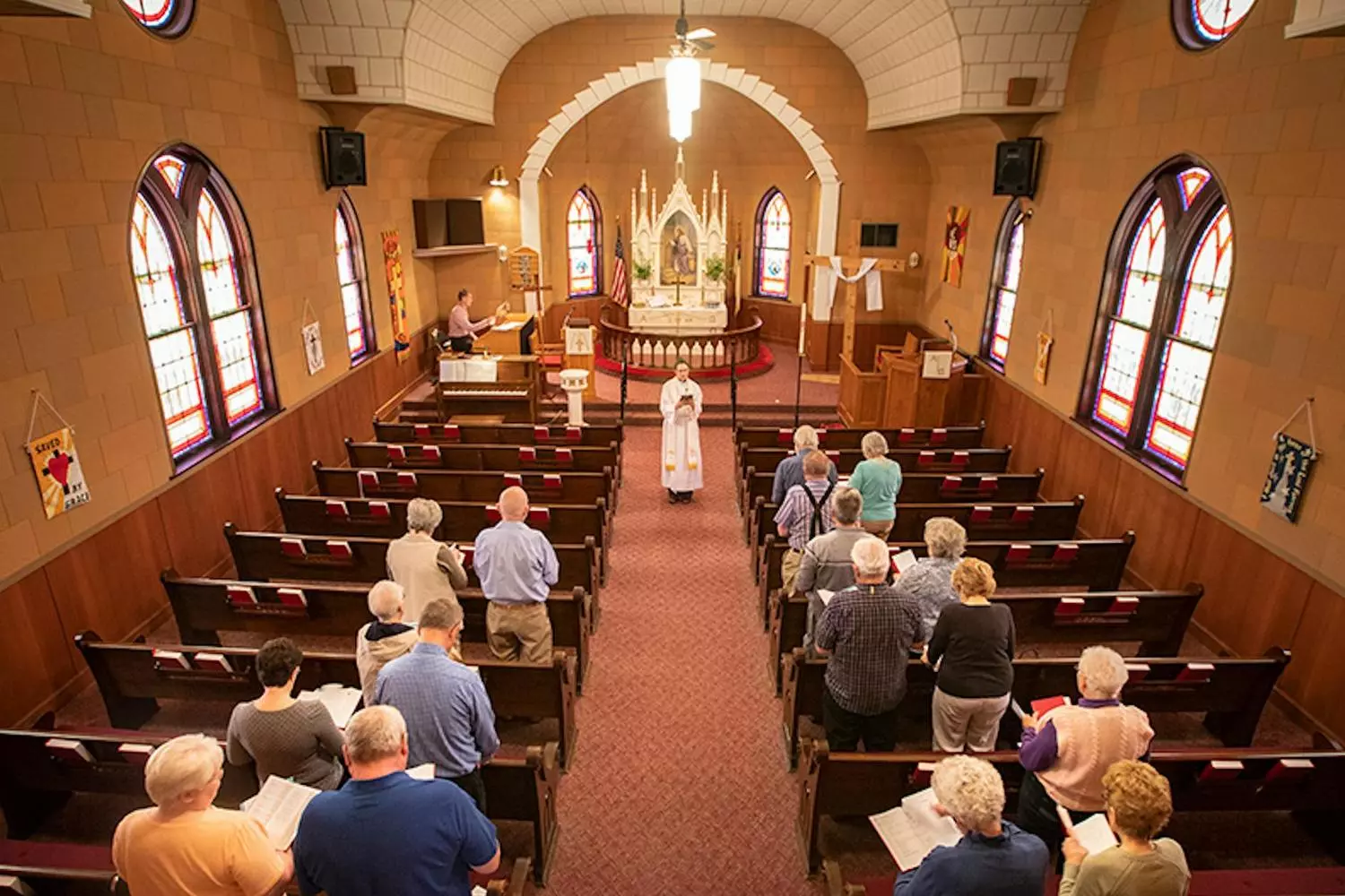 Catholic Mass in the USA: Tradition and Faith in Modern America A solemn Catholic Mass in a majestic U.S. cathedral: priests, parishioners, and traditional rites beneath stained glass windows