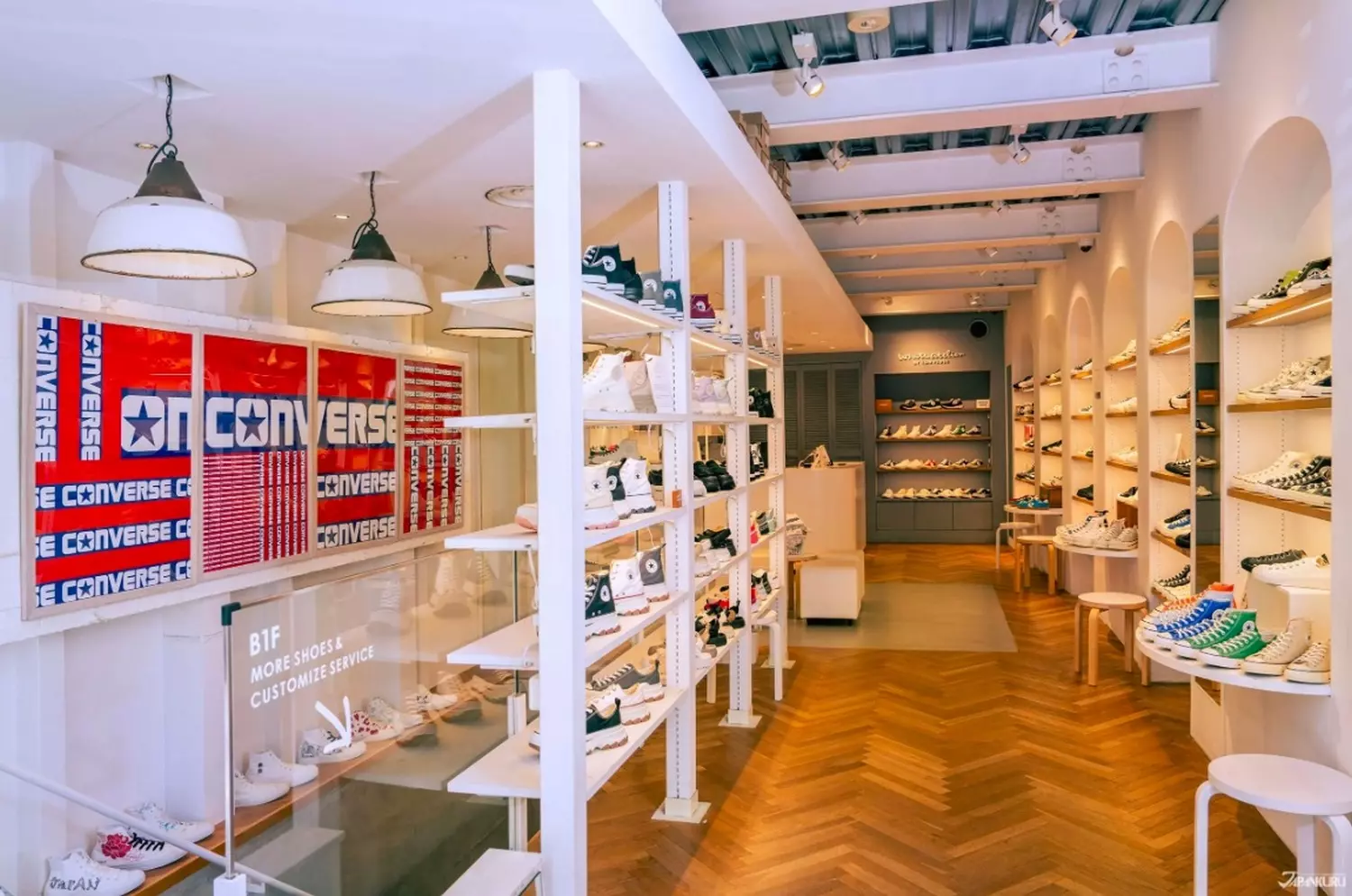 Where legends are born #ForeverConverse Converse Store: A wall of classic Chuck Taylor All-Stars, a custom design station, and vintage basketball details in an industrial-inspired space