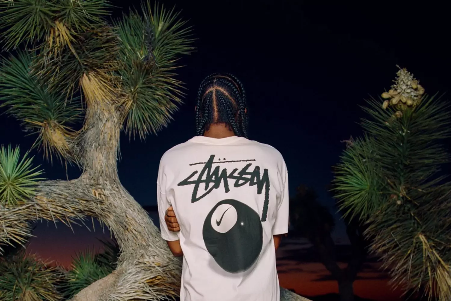 A t-shirt as a pass to the street party A guy in an oversized Stüssy t-shirt with a vintage logo