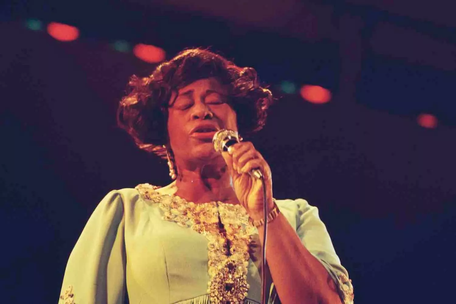 Lady Ella in Her Element — A Moment of Musical Magic Ella Fitzgerald performing on stage with a microphone, mid-song, exuding passion and energy