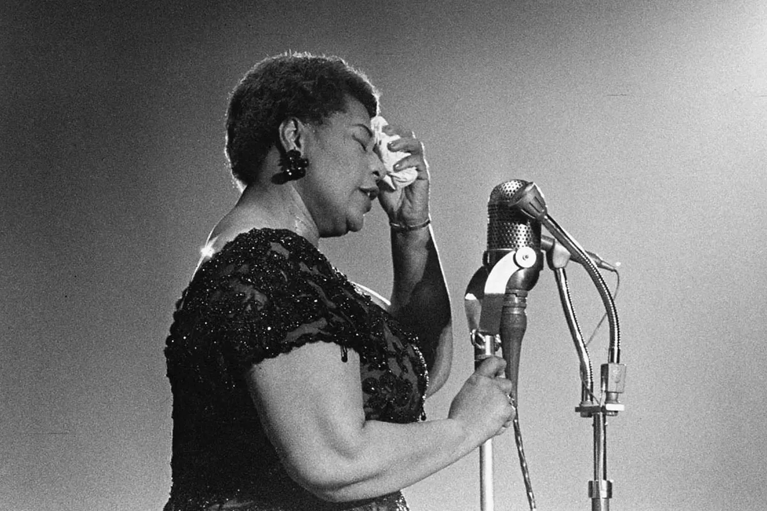Ella Fitzgerald: The Timeless Voice of Jazz Ella Fitzgerald performing on stage with a microphone, mid-song, exuding passion and energy