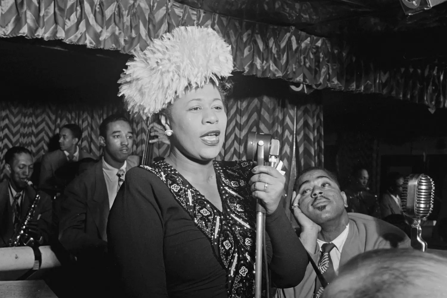 Lady Ella in Her Element — A Moment of Musical Magic Ella Fitzgerald performing on stage with a microphone, mid-song, exuding passion and energy