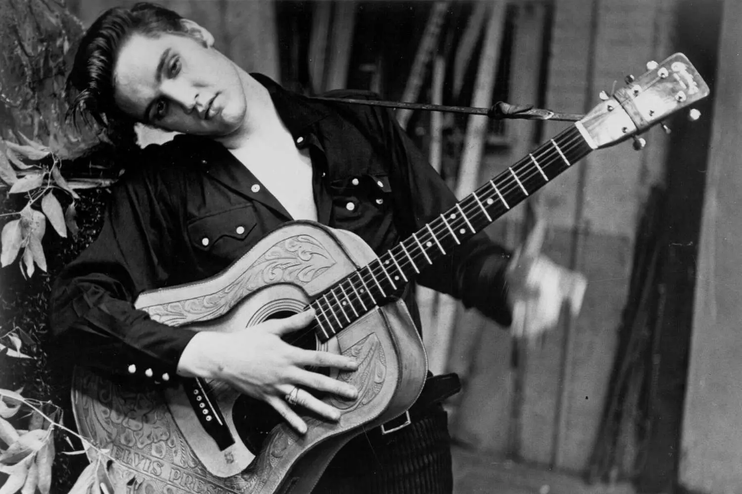 Elvis Presley in his early years — the beginning of a legend with a guitar in hand Young Elvis Presley with a guitar
