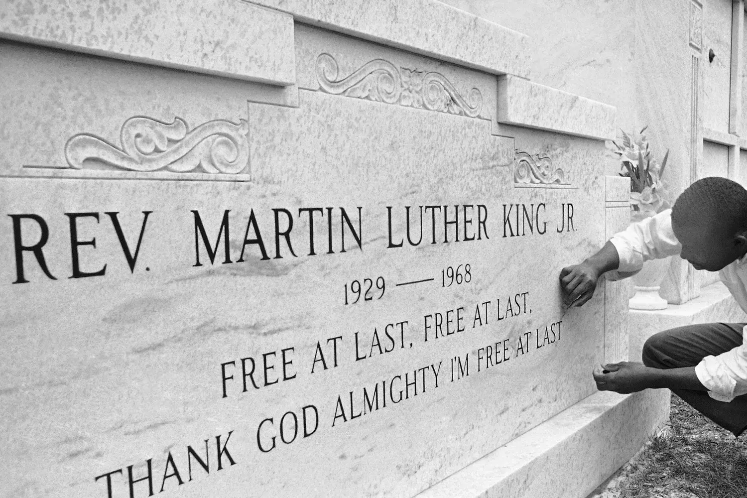Martin Luther King Jr.'s Grave: A Site of Remembrance and Inspiration The memorial at Martin Luther King Jr.'s gravesite: a stone tombstone engraved with his name, surrounded by flowers and a green lawn