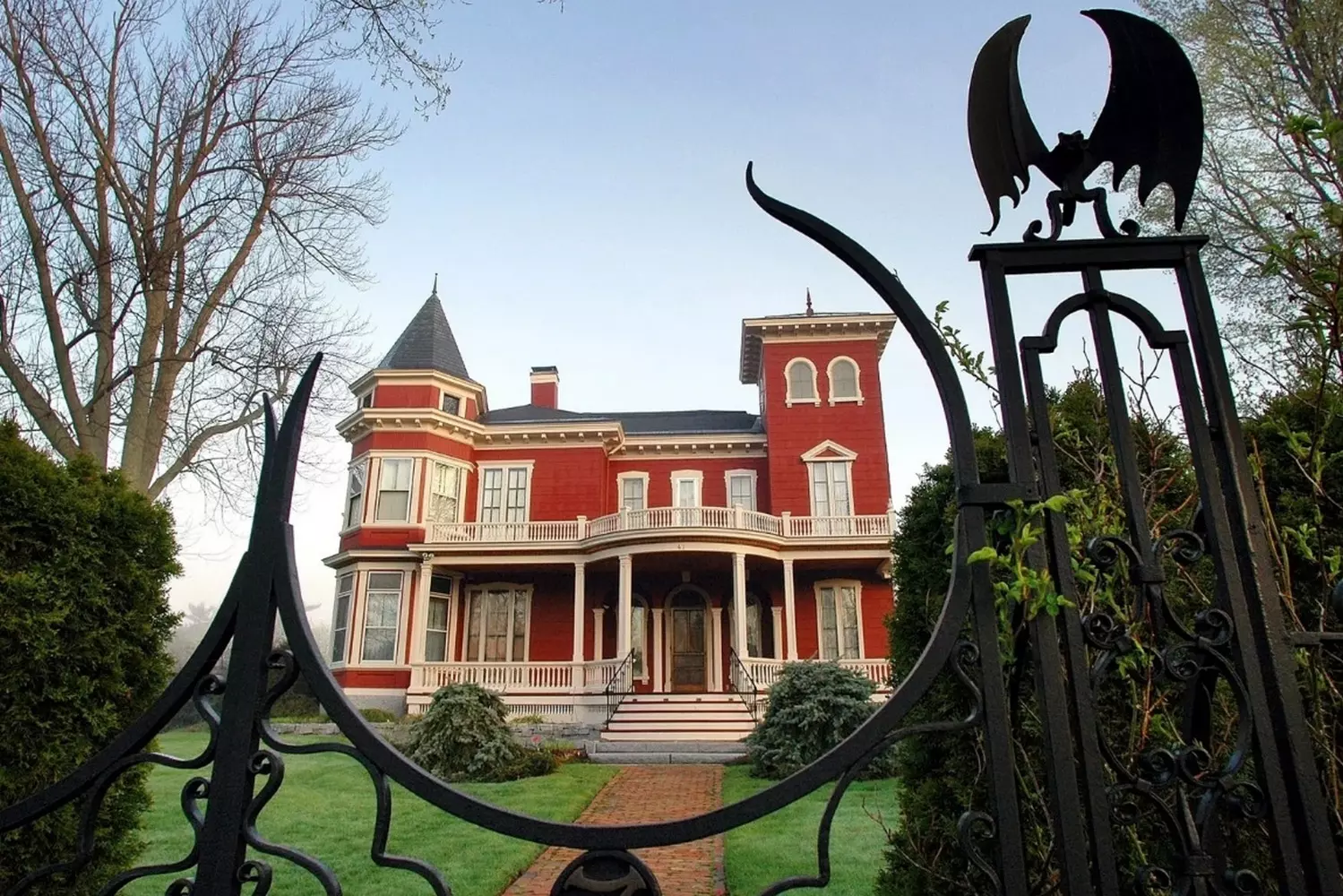 Stephen King's Gothic Mansion: Where Nightmares Are Born Stephen King's iconic Gothic-style home in Bangor, Maine, with its distinctive wrought-iron gates and eerie Victorian architecture that inspired many of his horror settings