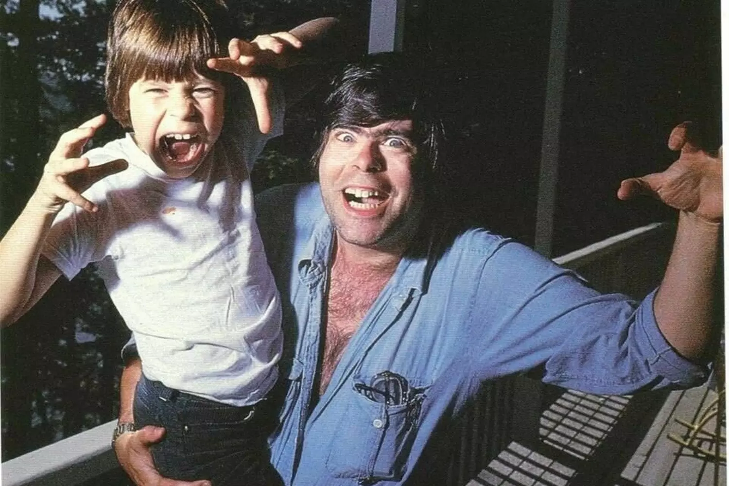 Stephen King with His Son: A Rare Family Moment from the Horror Master's Early Years Young Stephen King holding his son in a tender fatherly embrace, showing the personal side of the future King of Horror during his early writing career