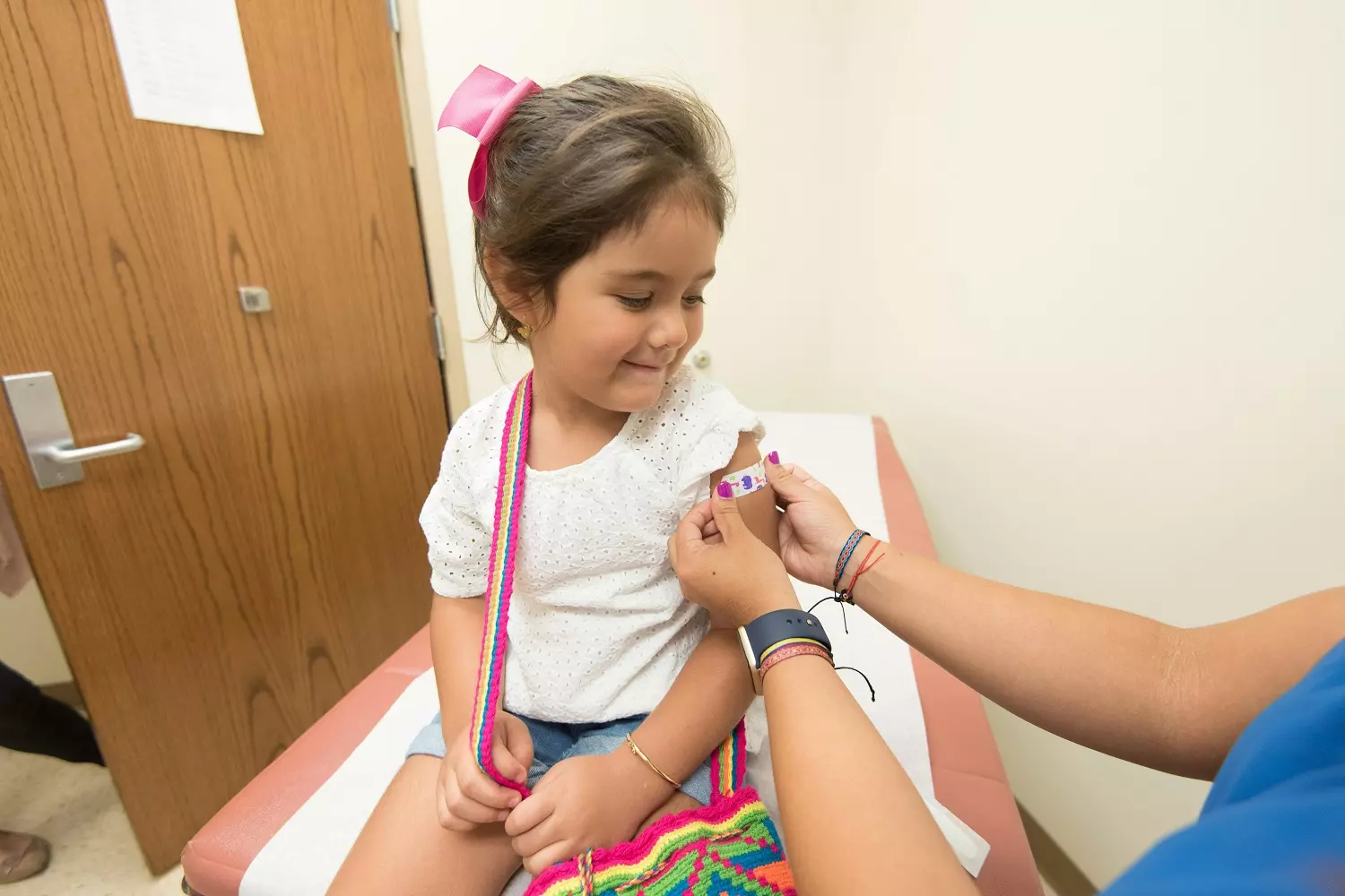 A child receives a vaccination for school enrollment A child receives a vaccination for school enrollment