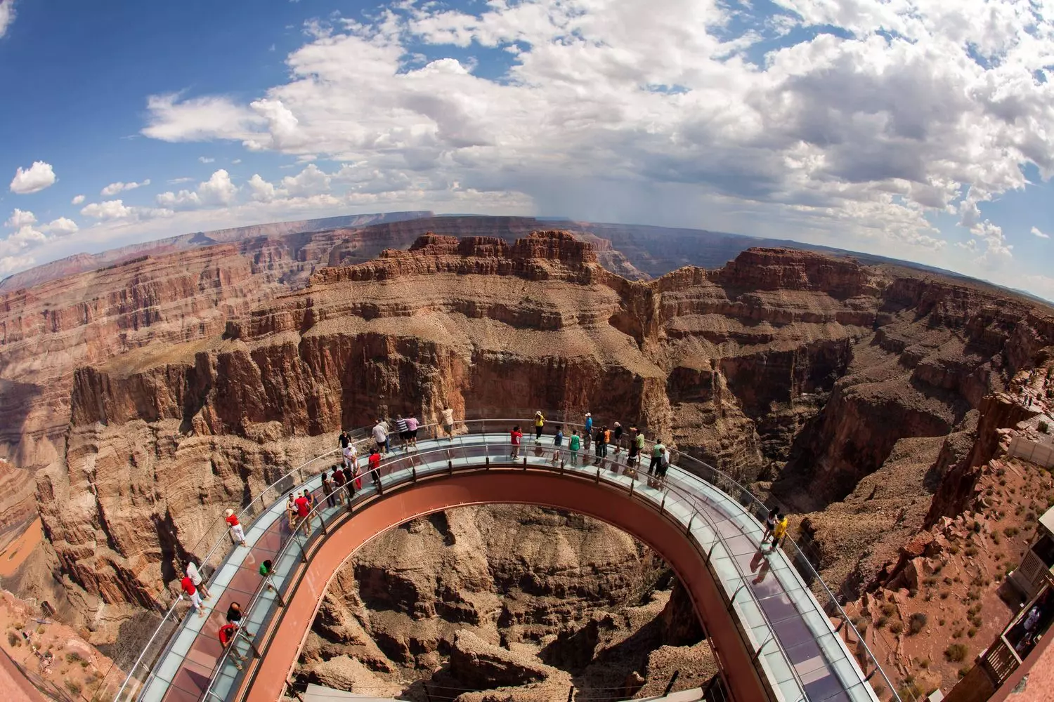 Walking on Air: Breathtaking Views from Grand Canyon Skywalk Glass-bottomed Grand Canyon Skywalk extending over the edge of the canyon with dramatic views of the steep cliffs and Colorado River below
