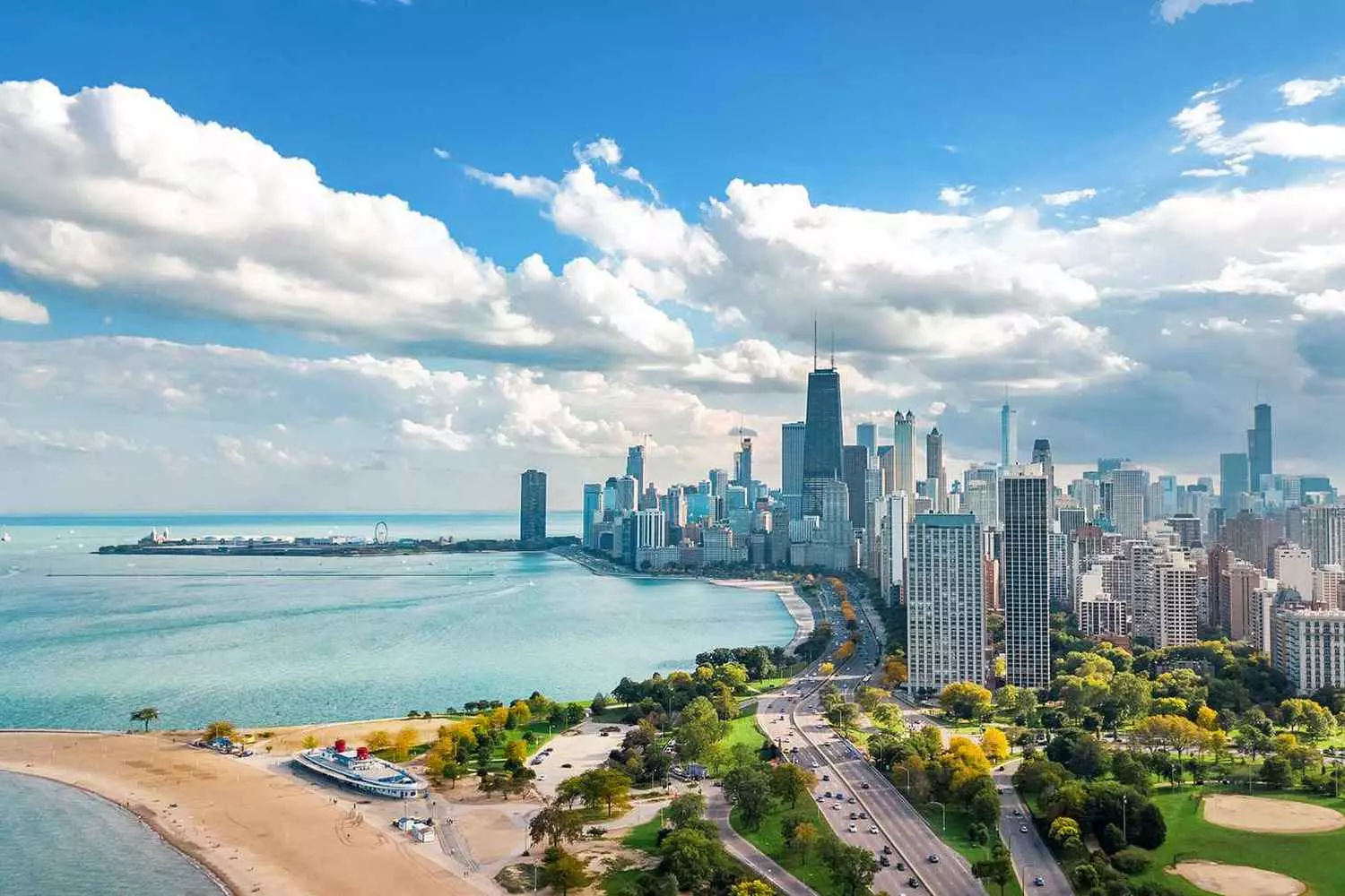 Lake Michigan: The Sapphire of the Great Lakes Aerial view of Lake Michigan's stunning turquoise waters meeting sandy shores, with Chicago's skyline visible in the distance on a clear day