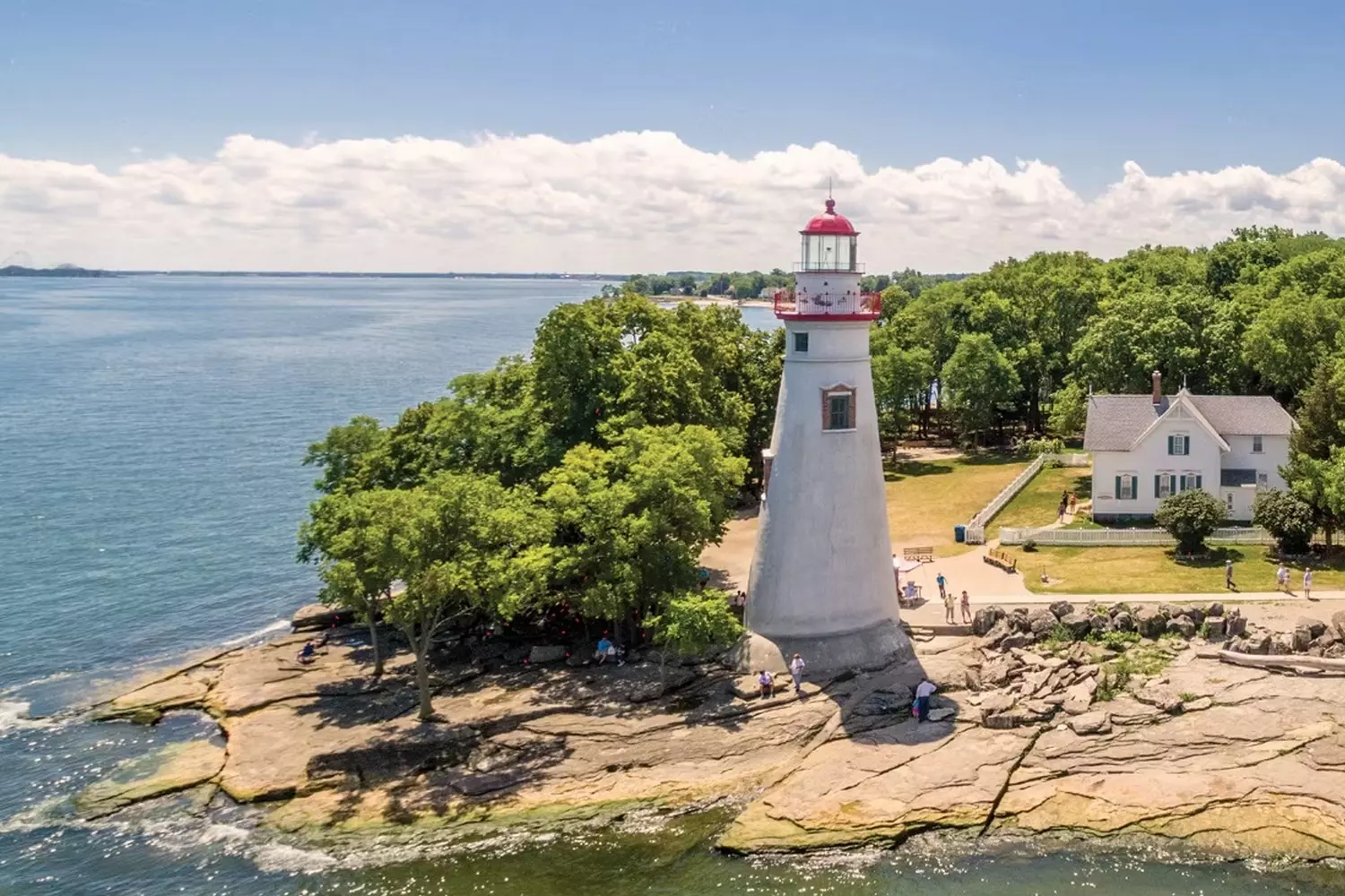 Lake Erie: The Shimmering Heart of the Great Lakes Aerial view of Lake Erie's vast blue waters meeting lush green shorelines, with visible wave patterns and scattered islands dotting the surface