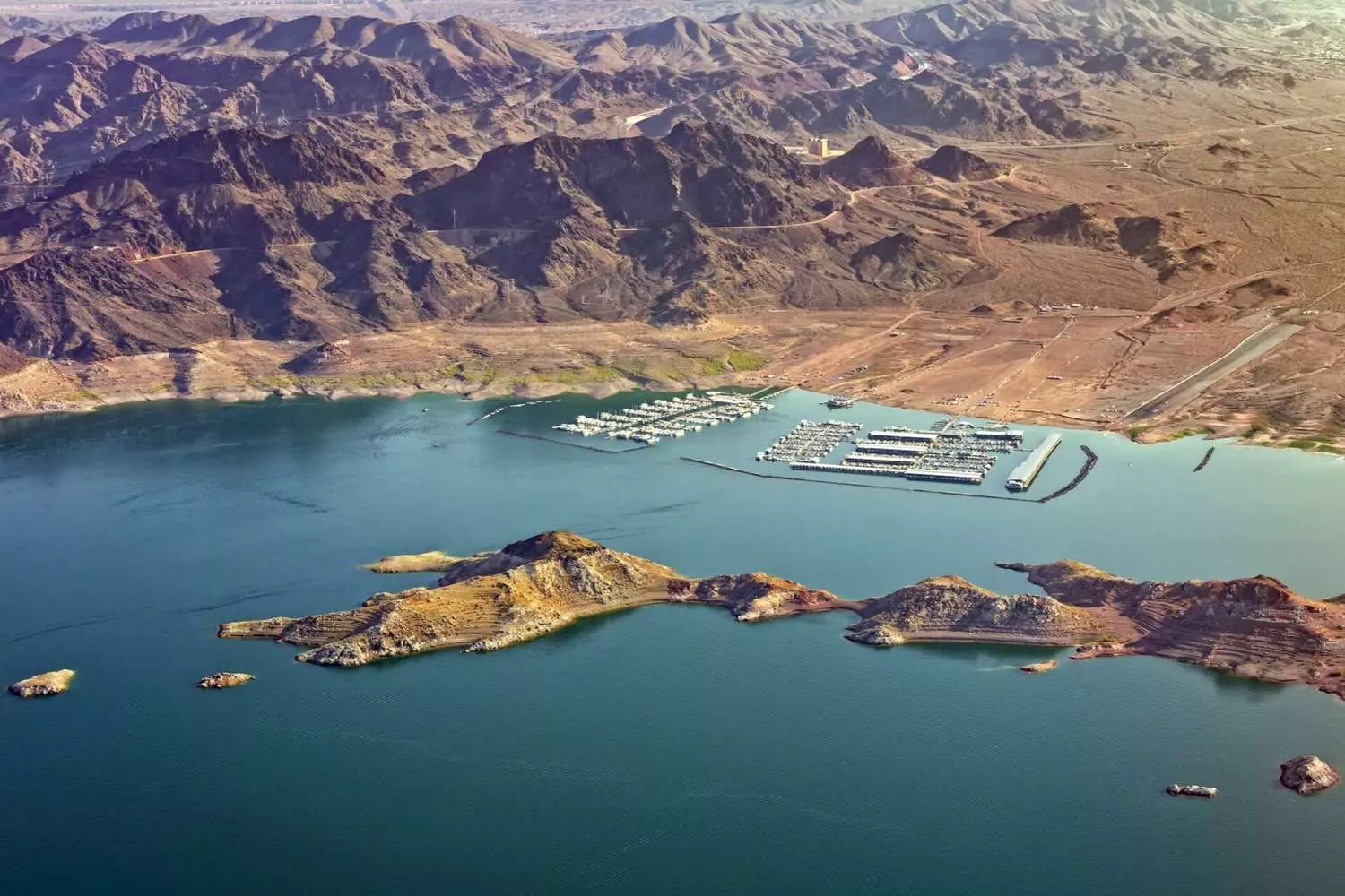 Scenic aerial photo of Lake Mead marina in Nevada Aerial view of Lake Mead marina surrounded by deep blue water and desert cliffs