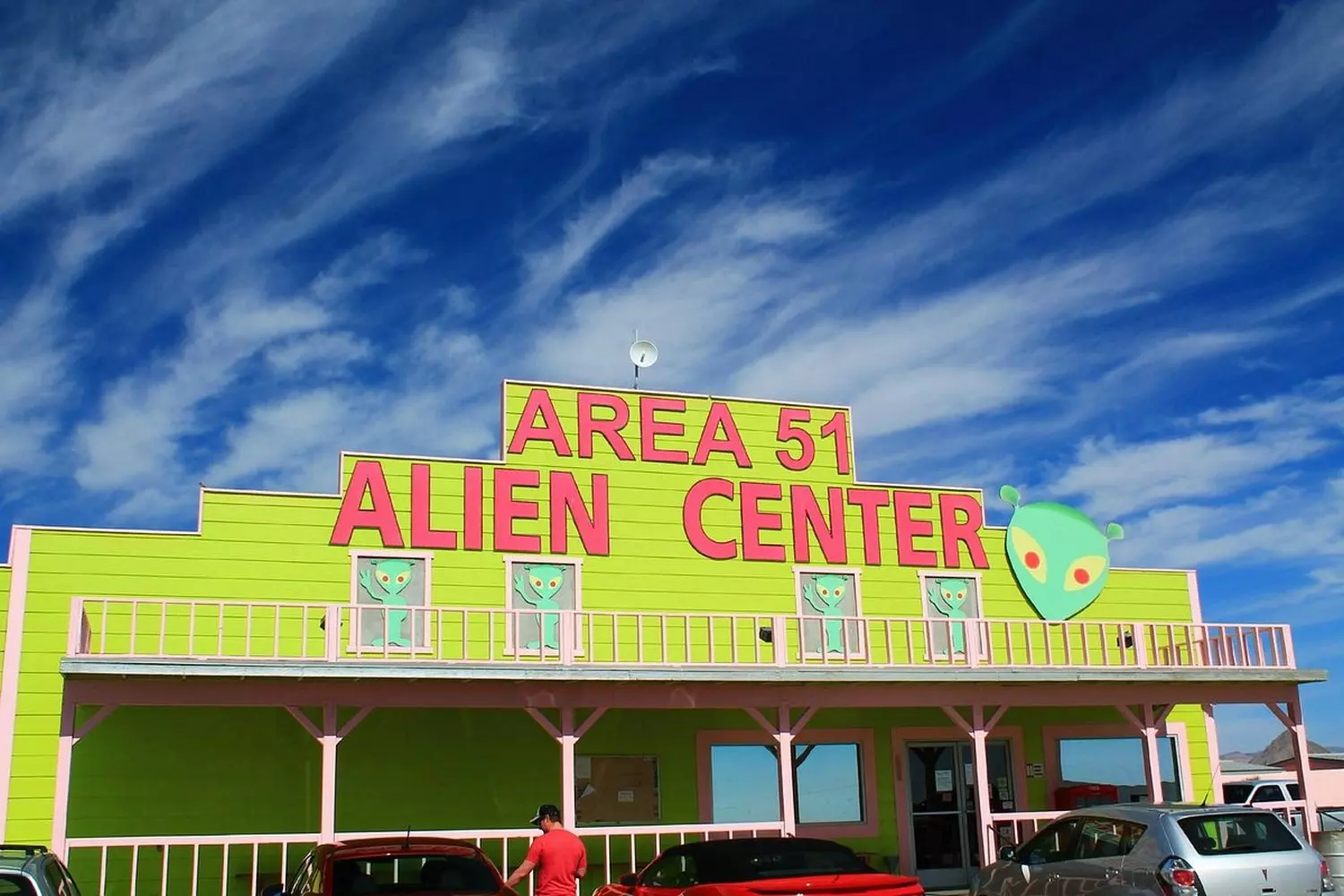 Area 51 Museum: Nevada's Quirkiest UFO & Military History Exhibit Exterior of the Area 51 Museum with UFO-themed displays and alien figurines visible through windows